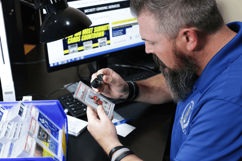 A BGS grader examining a sports card.