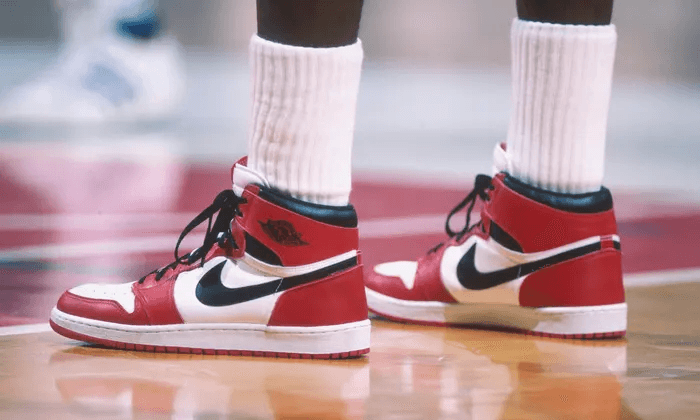 Michael Jordan wearing red and white Jordans on the court